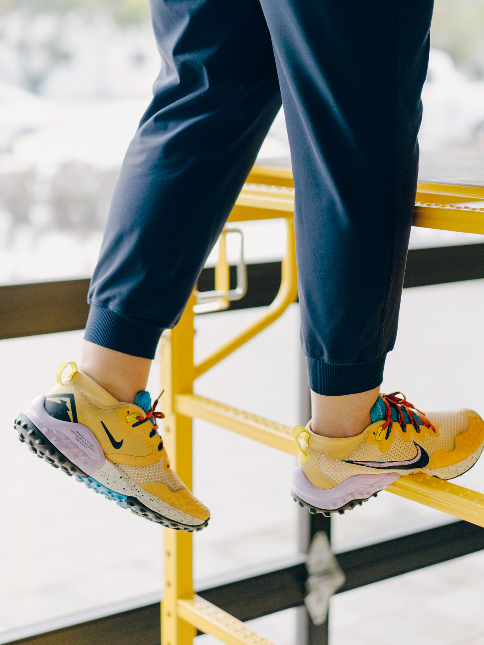 Legs of a person climbing a scaffold