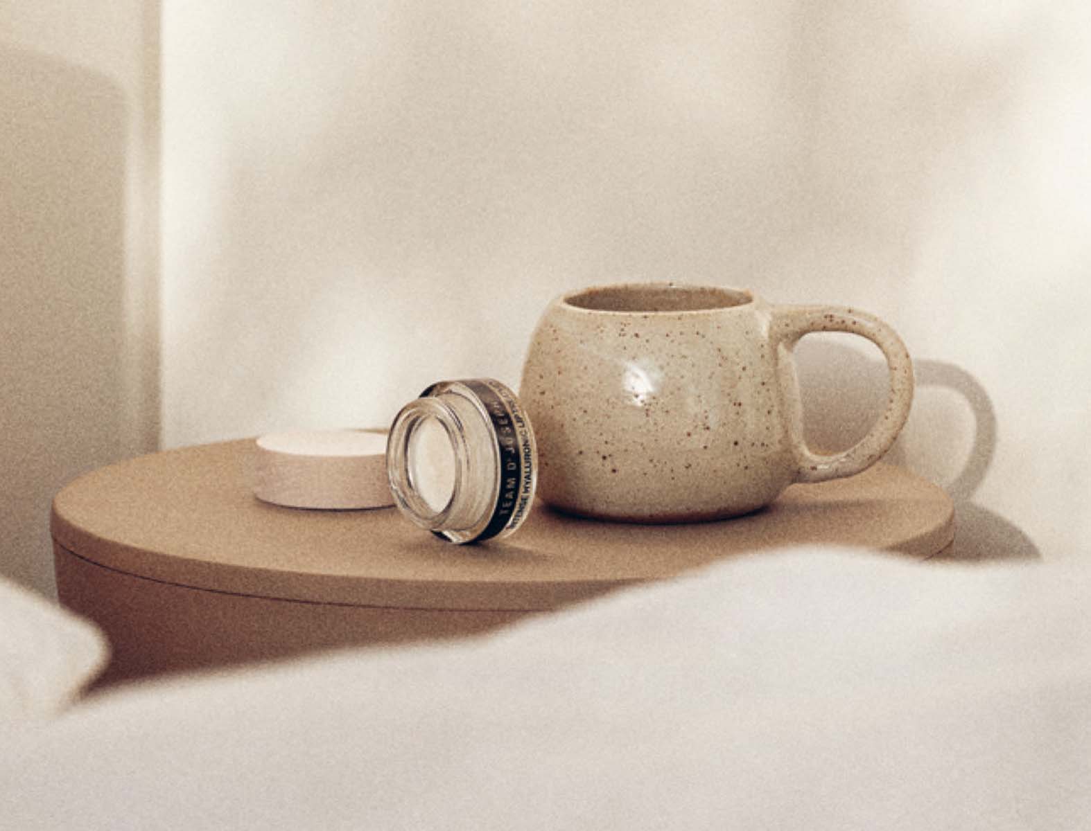 Close-up of a cup and a TEAM DR JOSEPH cream